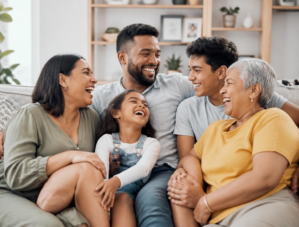 Three generations of a family smiling together in their living room